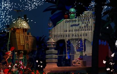 A display of a stage with a building and fireworks