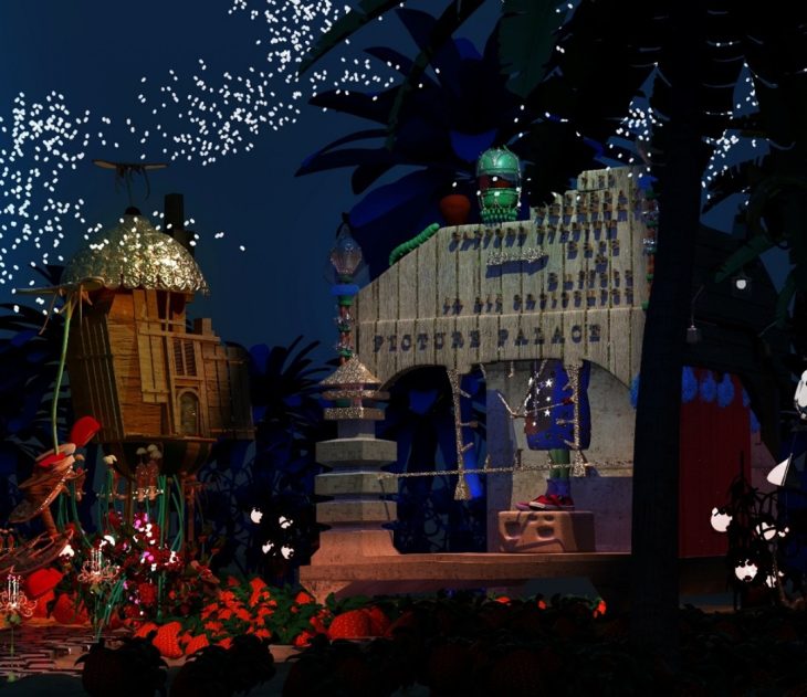 A display of a stage with a building and fireworks